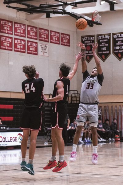 Skyline freshman guard Dominic Walker shots over two Foothill defenders. 