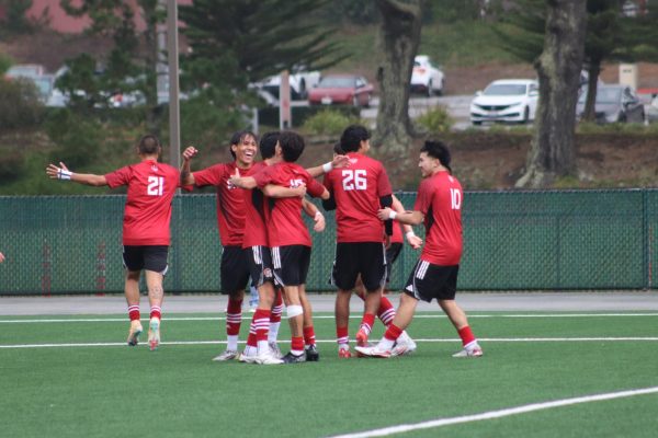 Skyline players surround sophomore striker Beto Fernandez after his goal to put Skyline up 2-1 in the second half.