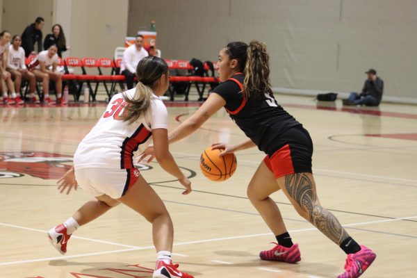 Sophomore guard Desiree Perez, pictured in Friday's win over CCSF, heavily contributed to Skyline's offense in the second half with multiple layups. Former Trojan guard Alexis Cornejo, pictured guarding Perez, scored six points for CCSF in the Friday night matchup.