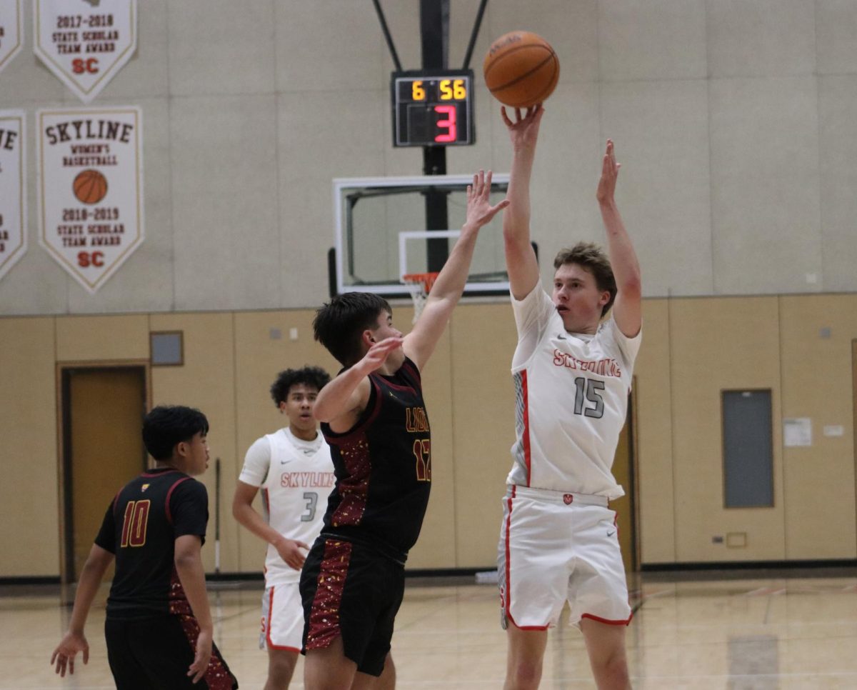 Skyline freshman guard Asher Meighen shot a 3-pointer over De Anza  freshman guard Gio Brovelli.
