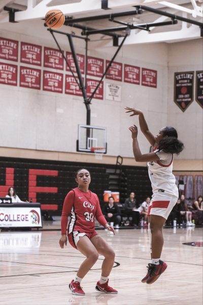 Trojan freshman Nia Rodgers shots 3-pointer over former Trojan guard Alexis Cornejo. (File photo)