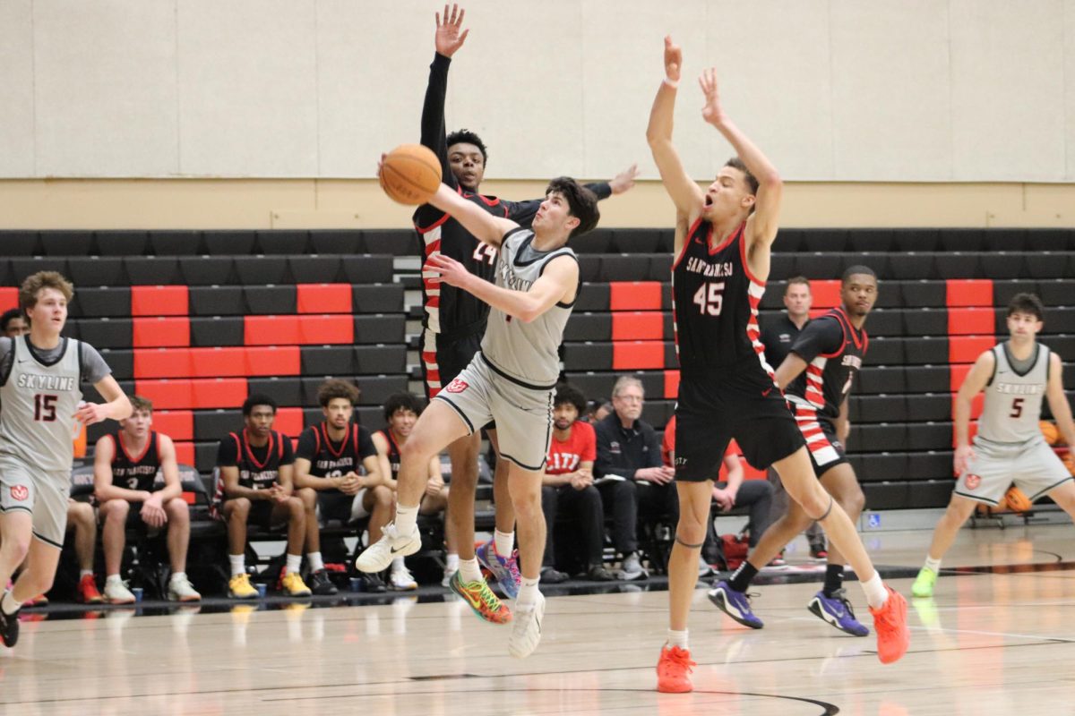Skyline point guard Zidane Auzarang goes for a layup with two CCSF defenders over him. 