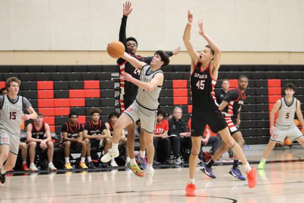 Skyline point guard Zidane Auzarang goes for a layup with two CCSF defenders over him. 