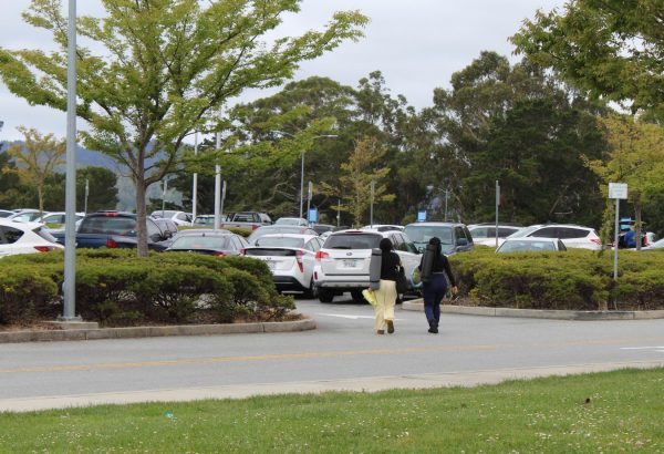 Students walk through CSM's Parking Lot A, as Lot B goes under construction.